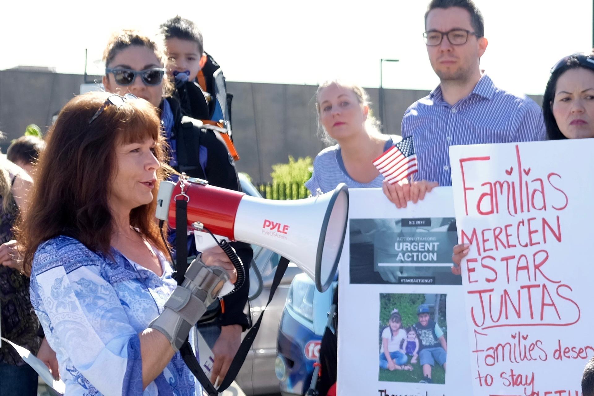 Sharlee Mullins Glenn speaks to demonstrators outside the Office of Homeland Security in West Valley City, Utah in May.