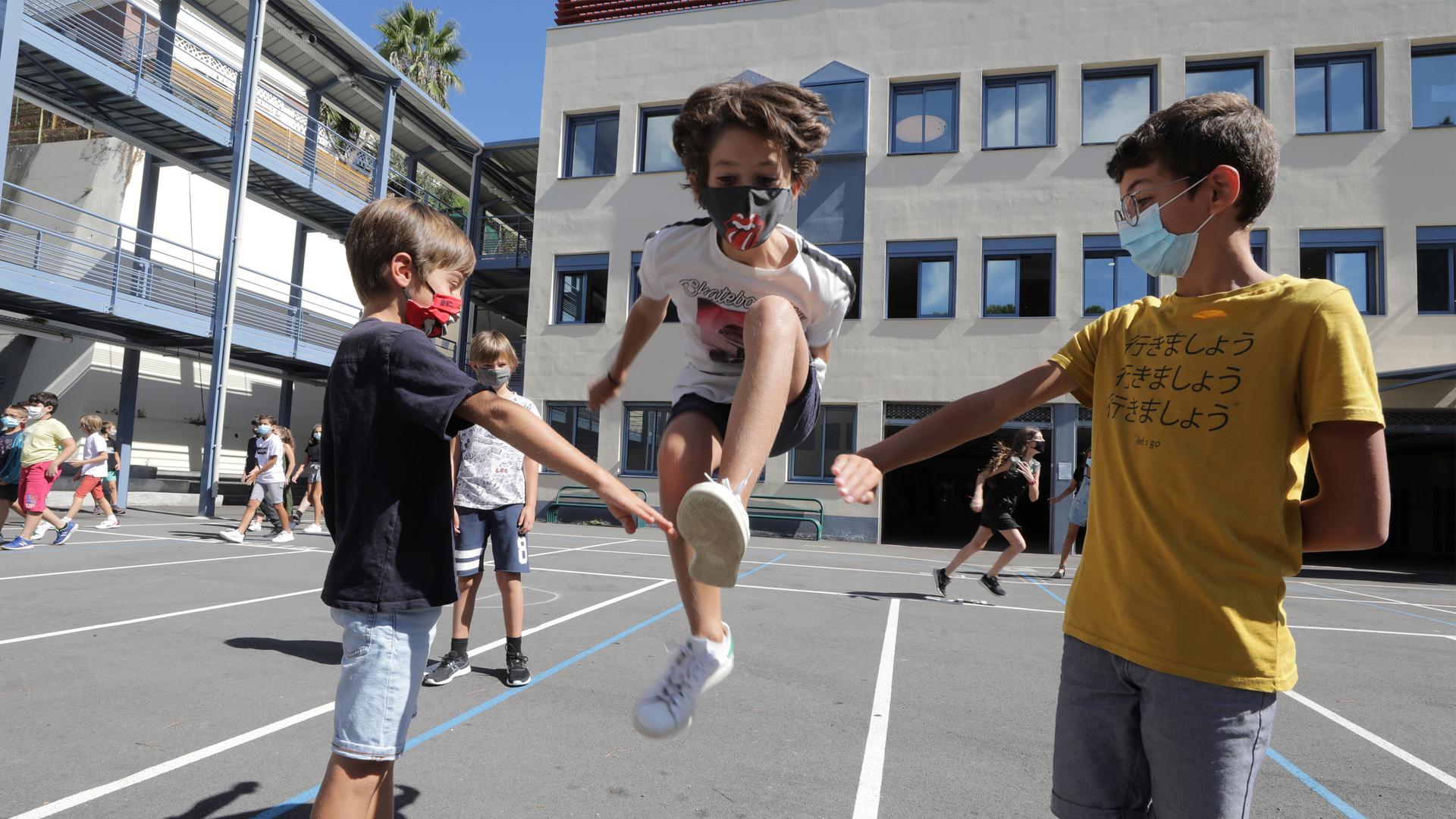Secondary school students play in the courtyard at the College Henri Matisse school during its reopening in Nice as French children return to their schools after the summer break.