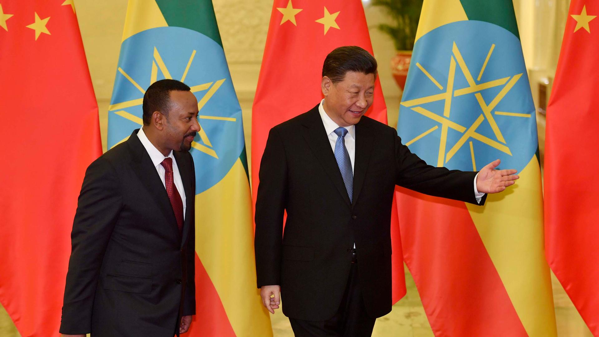 Ethiopia's Prime Minister Abiy Ahmed, left, is shown the way by Chinese President Xi Jinping before their meeting at the Great Hall of the People in Beijing,China, April 24, 2019.