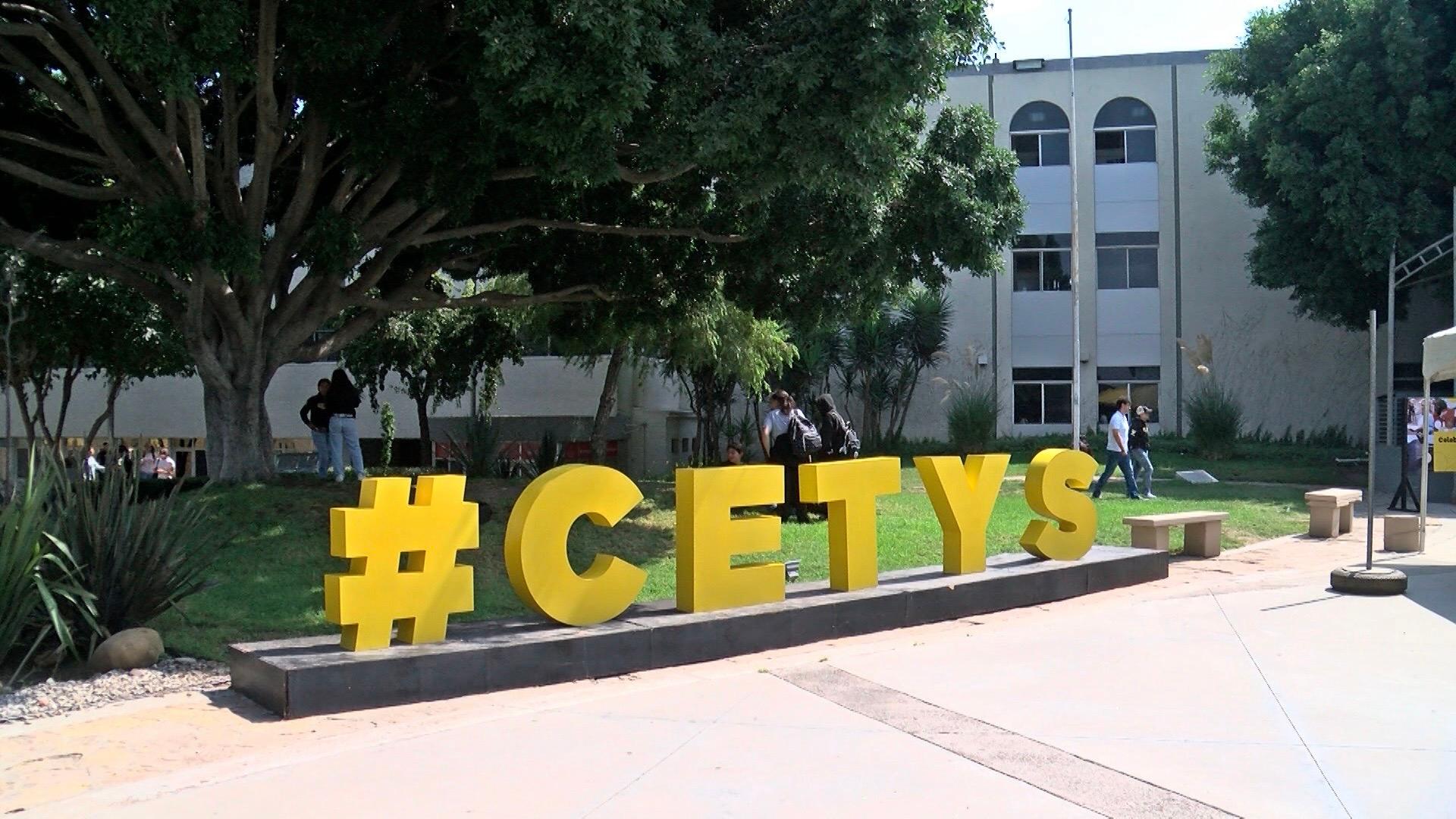College campus with large yellow block letters that spell out C-E-T-Y-S