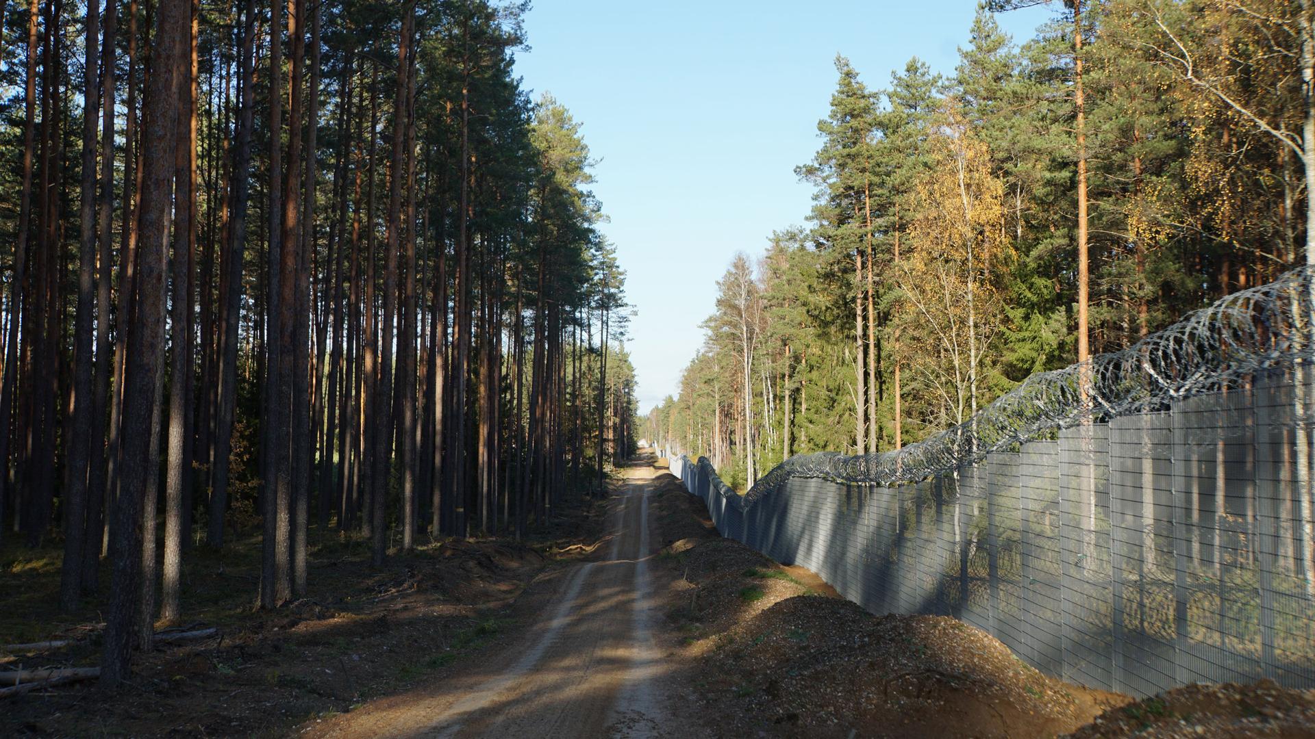 The border between Belarus and Latvia is about 100 miles long and is partially separated by a fence monitored by border officers.