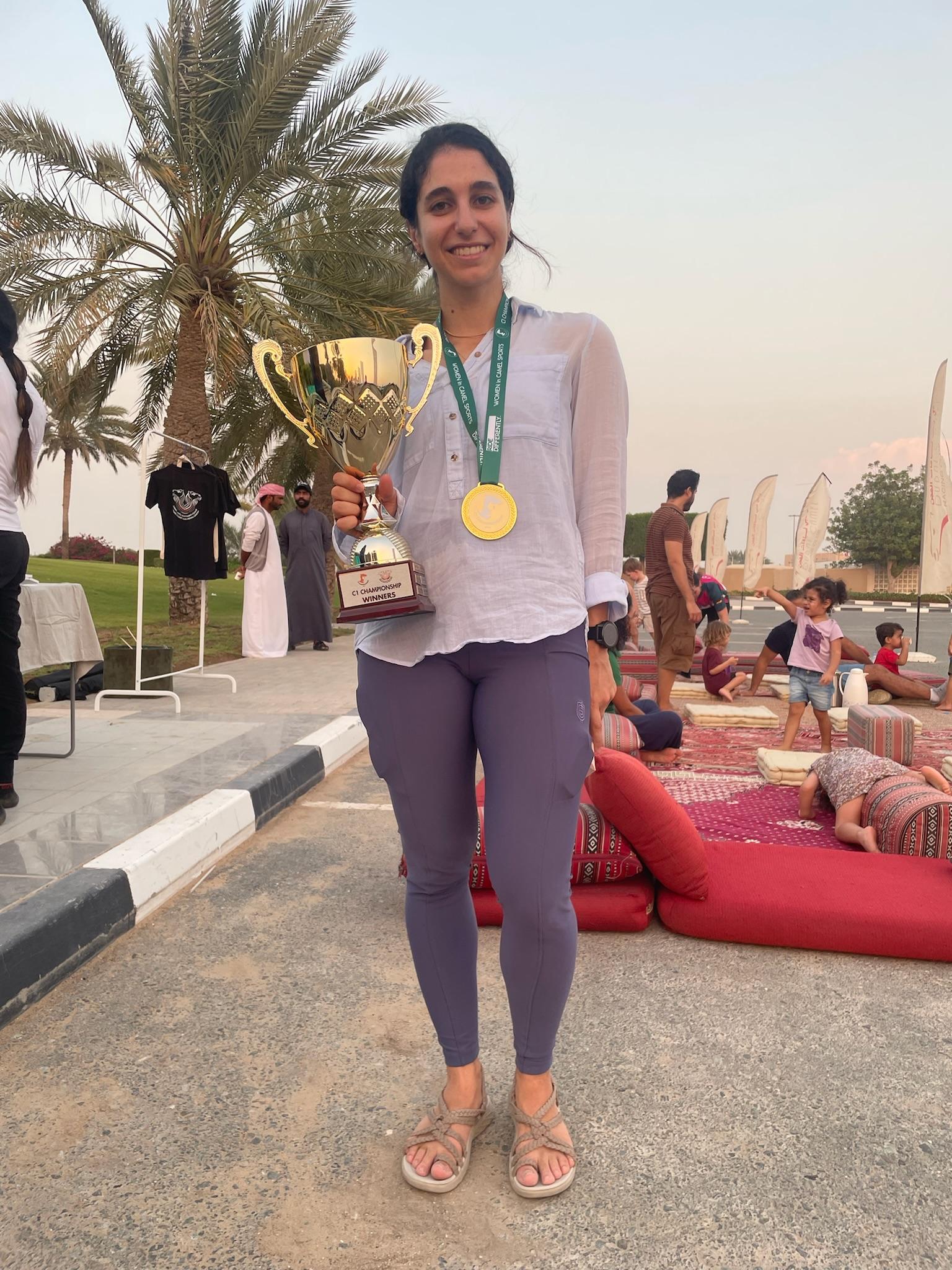 winner of camel race holds a trophy