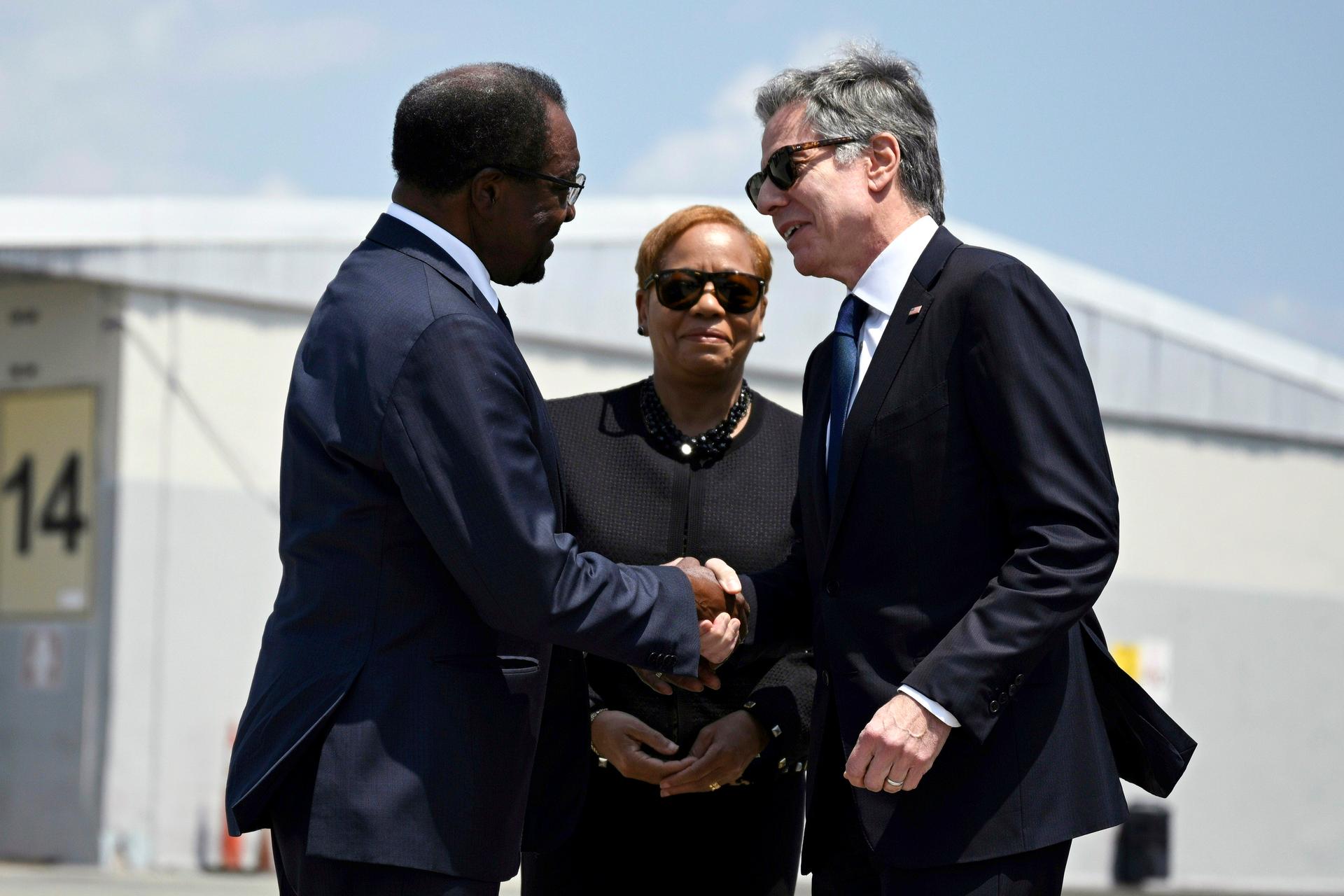 Secretary Blinken and the US ambassador to Jamaica shake hands