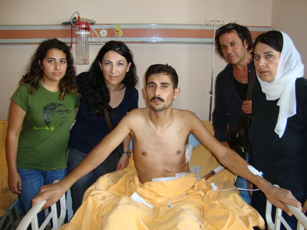 Mohja Kahf (right), her daughter, friend and brother-in-law, visiting a wounded Syrian man in Turkey.