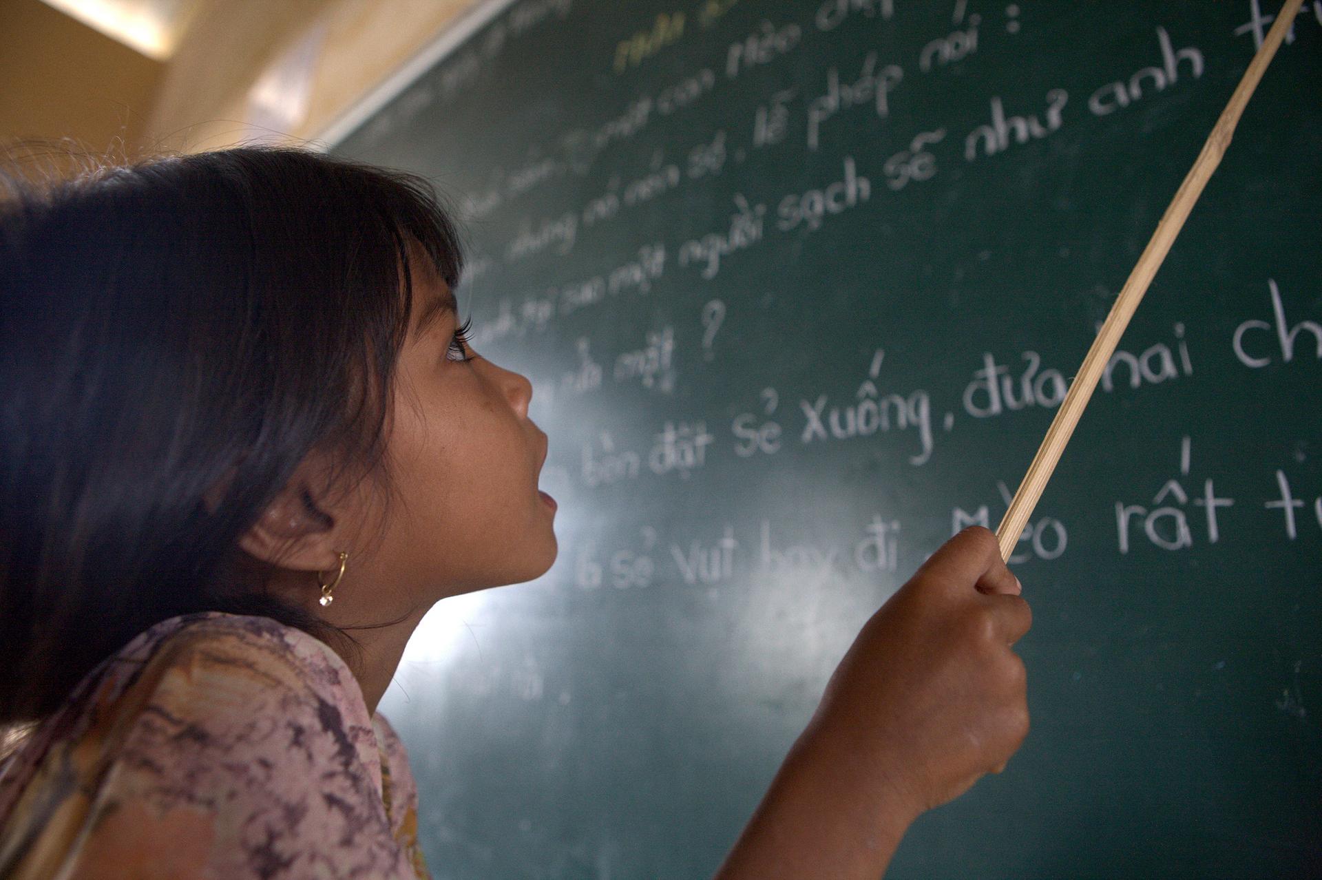 A student of Khmer descent learns Kinh language (the official Vietnamese language) at the Lac Hoa Primary School in Soc Trang province.