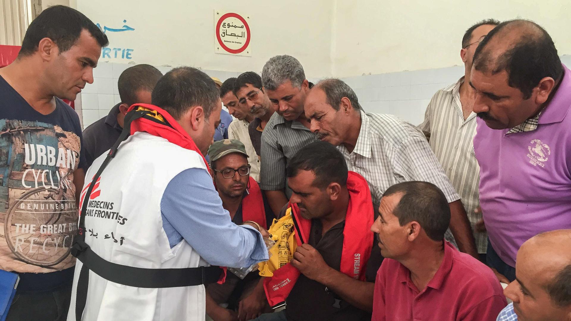 Tunisian fishermen try on life jackets offered by MSF at the end of the training. The fishermen say in general they lack the equipment to cope with boatloads of migrants and refugees in distress.