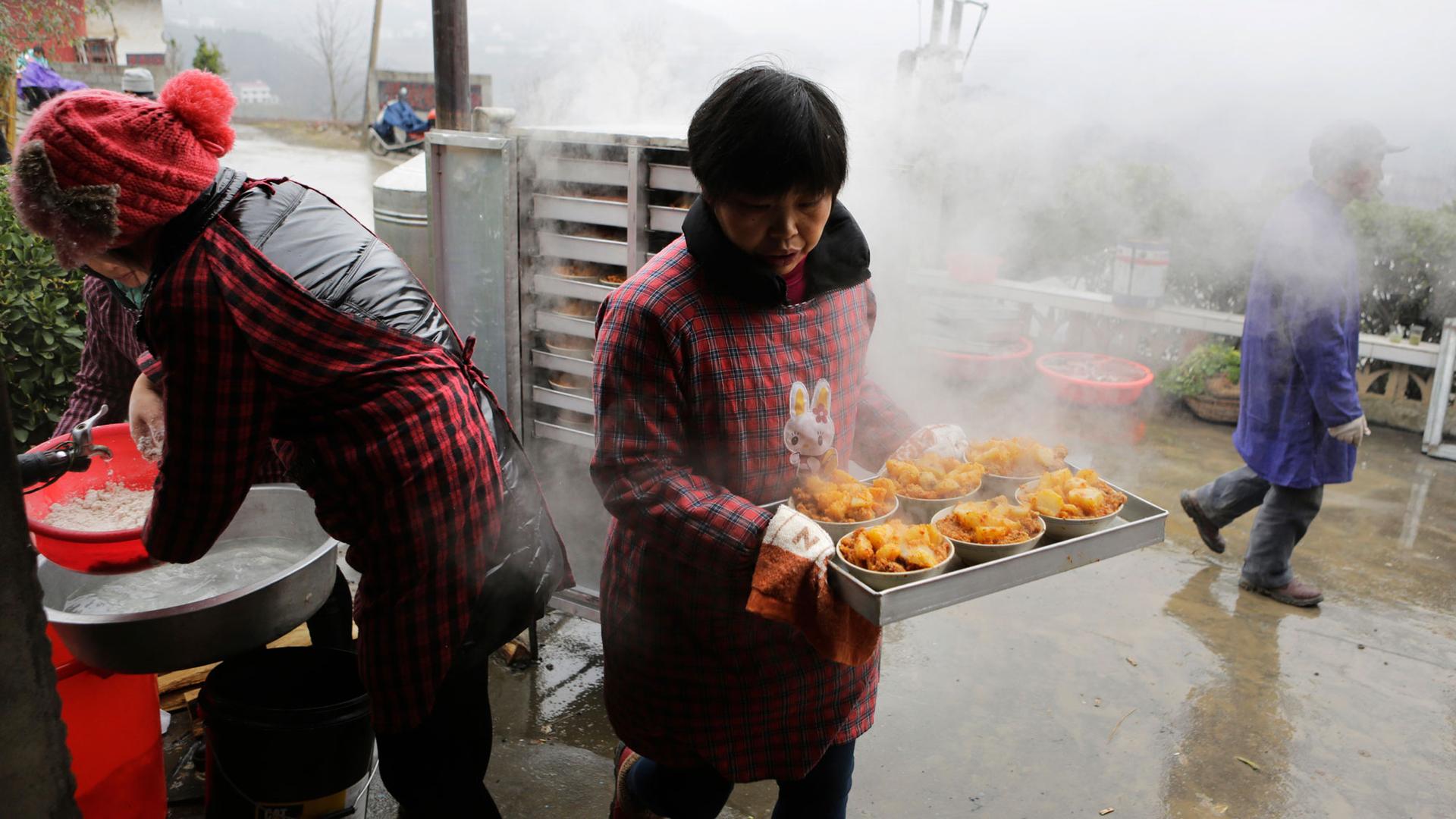 A local cook prepares a traditional ethnic Tujia wedding feast during celebrations marking the Lunar New Year in China’s Hubei province.