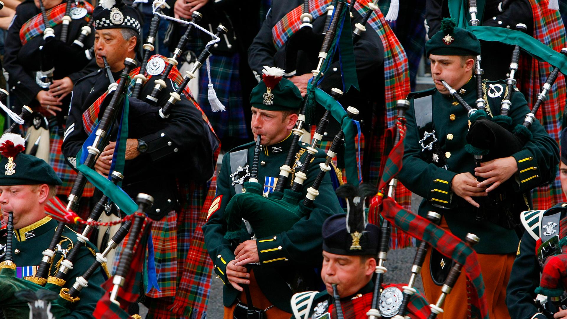 Pipers from the Edinburgh Military Tattoo Massed Pipes and Drums perform during the Edinburgh Fringe Festival parade in Holyrood Park in Edinburgh, Scotland.