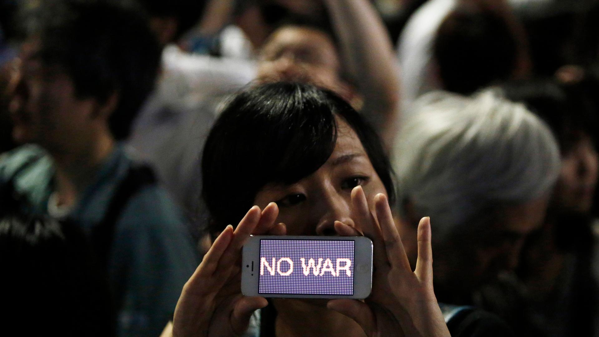 A protester at a rally against Japan's Prime Minister Shinzo Abe's push to expand Japan's military role.
