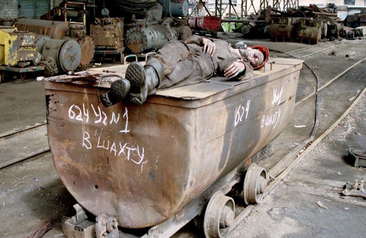 A Ukrainian miner sleeps on a coal trolley in the southeastern Ukrainian city of Donetsk in May 1998.