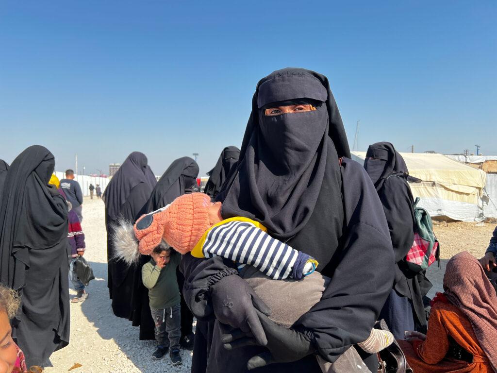 A woman at al-Hol camp holds her child who she says has been very sick.