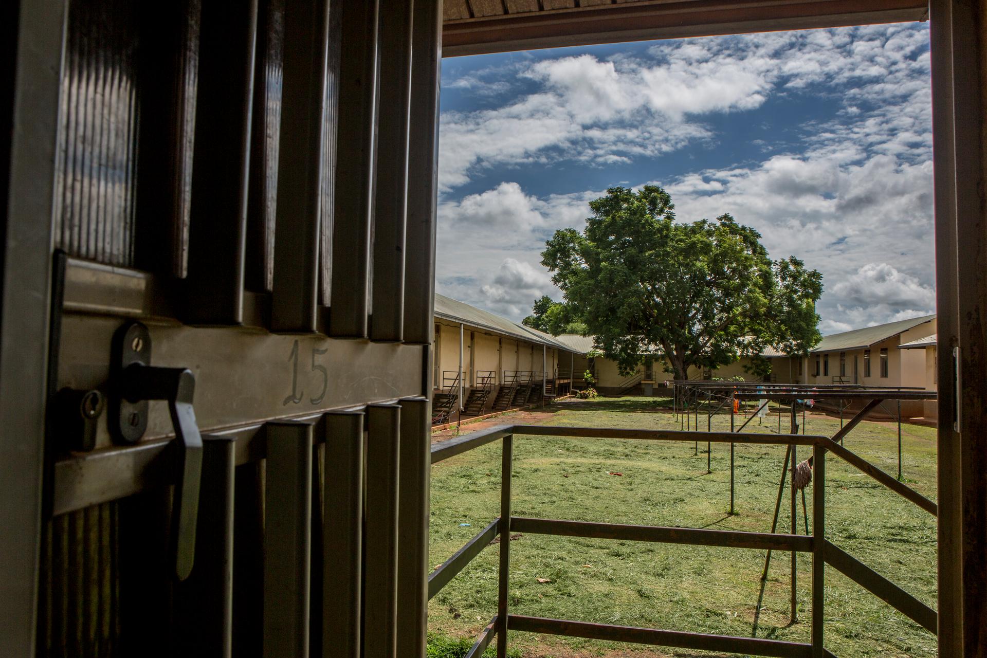Looking out of a door in the dormitory at St. Monica's Vocational School in Gulu, Uganda.
