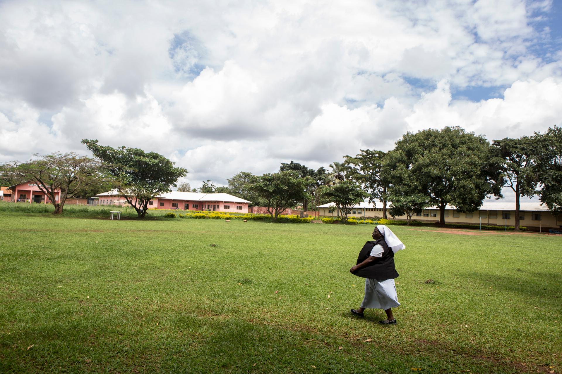Sister Rosemary striding across the yard at St. Monica Girls'  Vocational School.