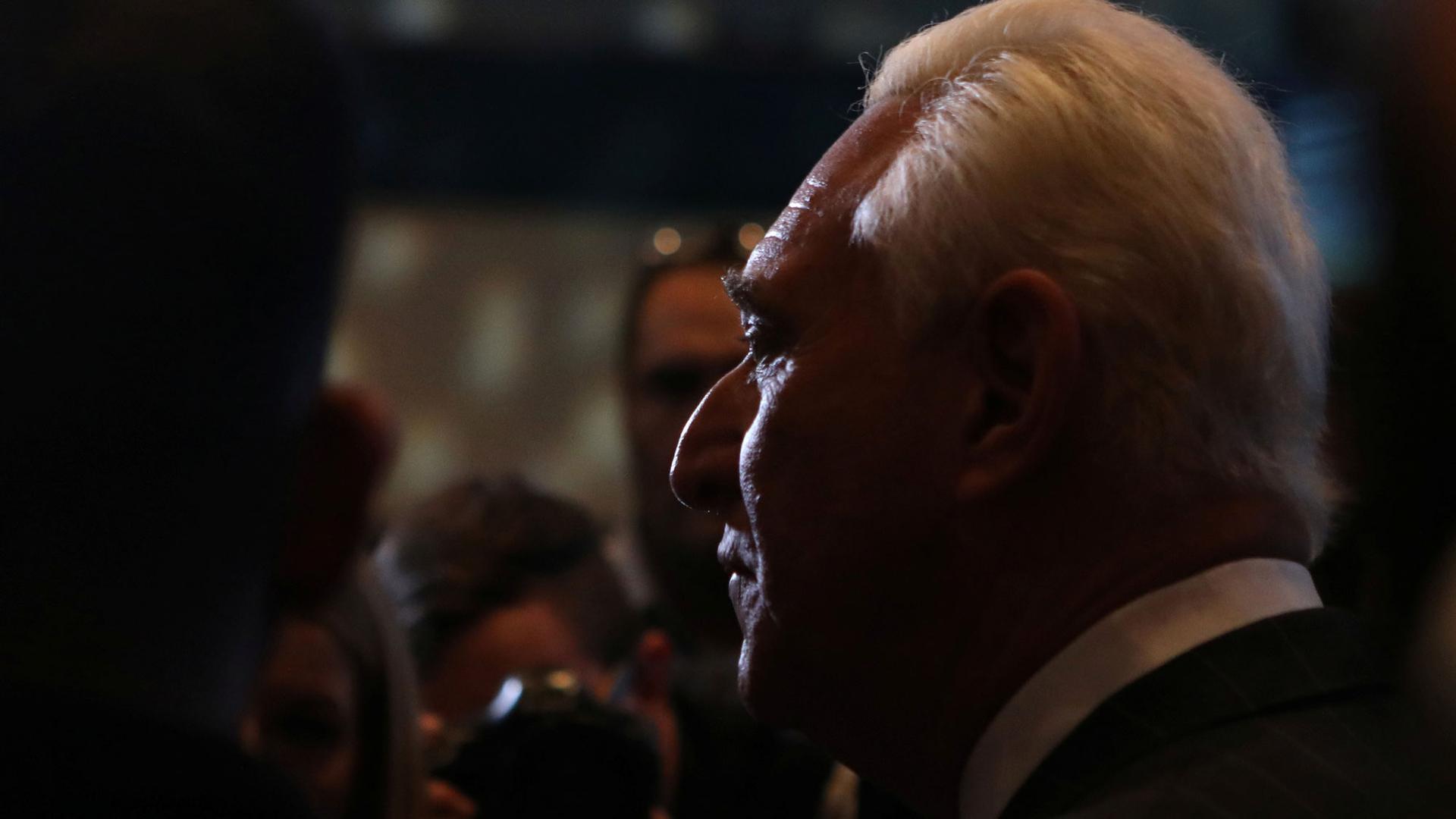 Political operative Roger Stone is shown in a profile portrait in high contrast.