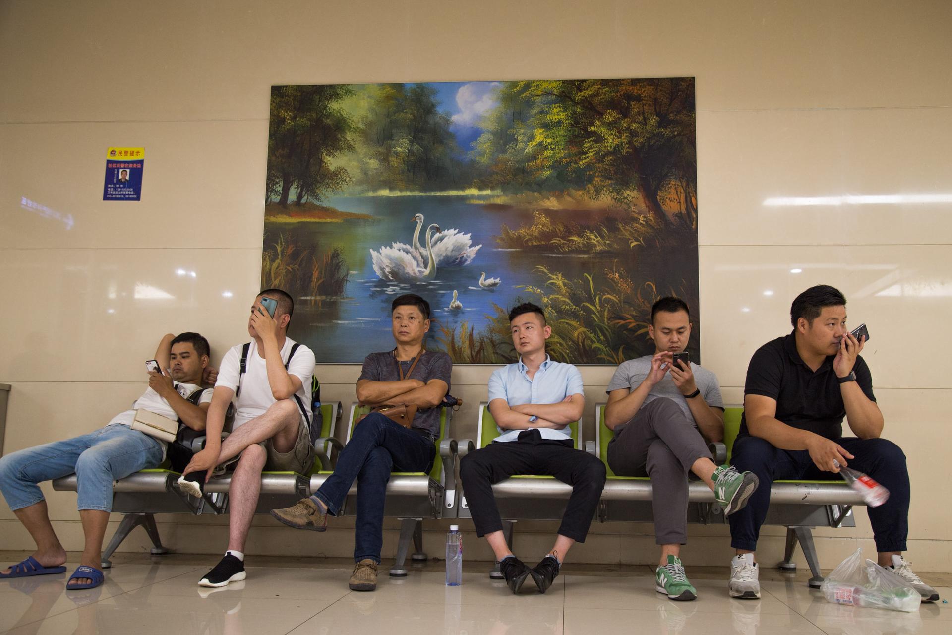 Men wait outside the gynecology consultation area at the People’s Liberation Army General Hospital in Beijing, China on July 30, 2019.