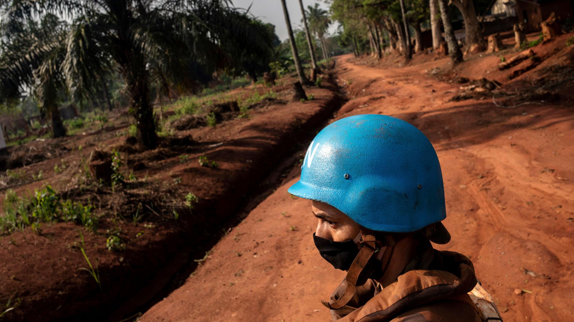 Moroccan UN peacekeepers wearing blue helmets patrol a rich soil road Bangassou, Central African Republic, Feb. 14, 2021. 
