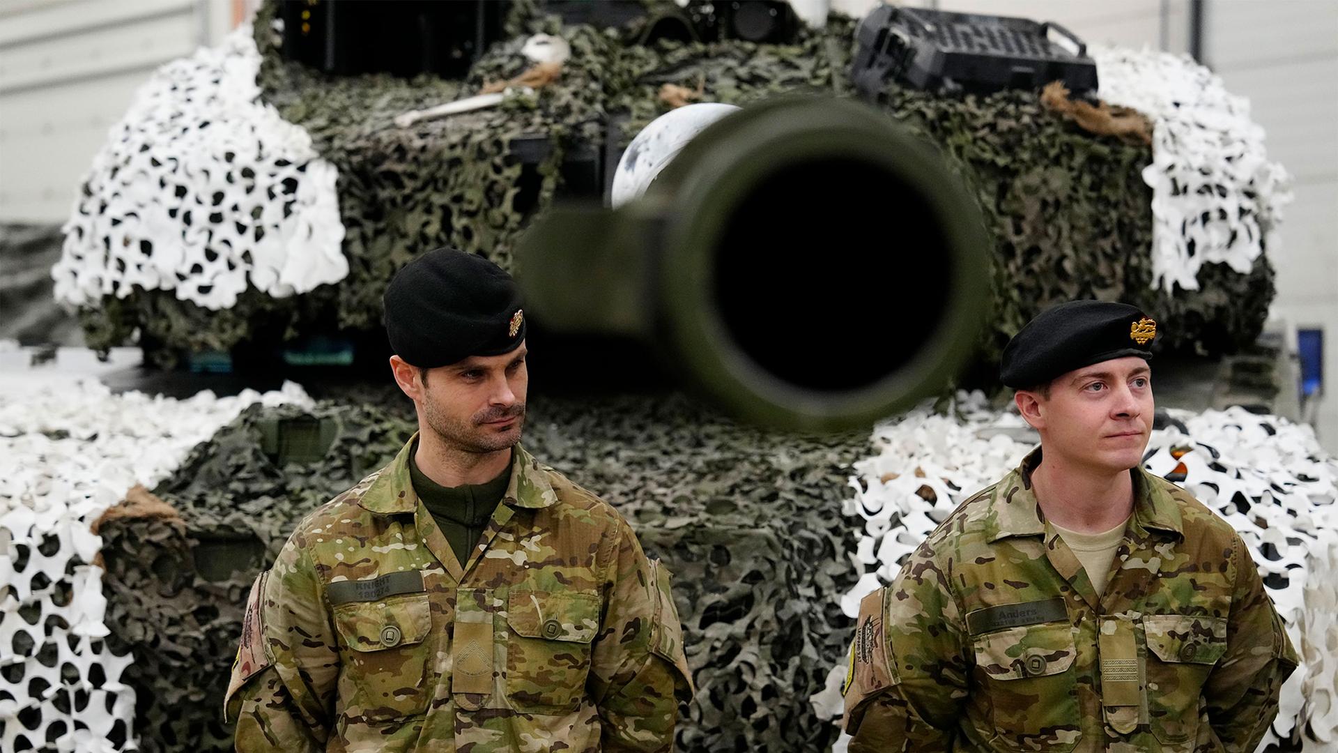 Denmark's military officers stand next to a Leopard 2A7 tank at the Tapa Military Camp, in Estonia, Jan. 19, 2023.