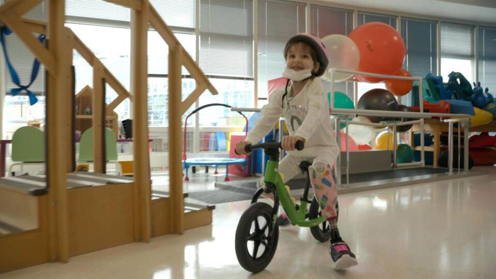 Karolina Daremyan bikes just six weeks after receiving her new prosthetic legs at Shriners Children's Boston.