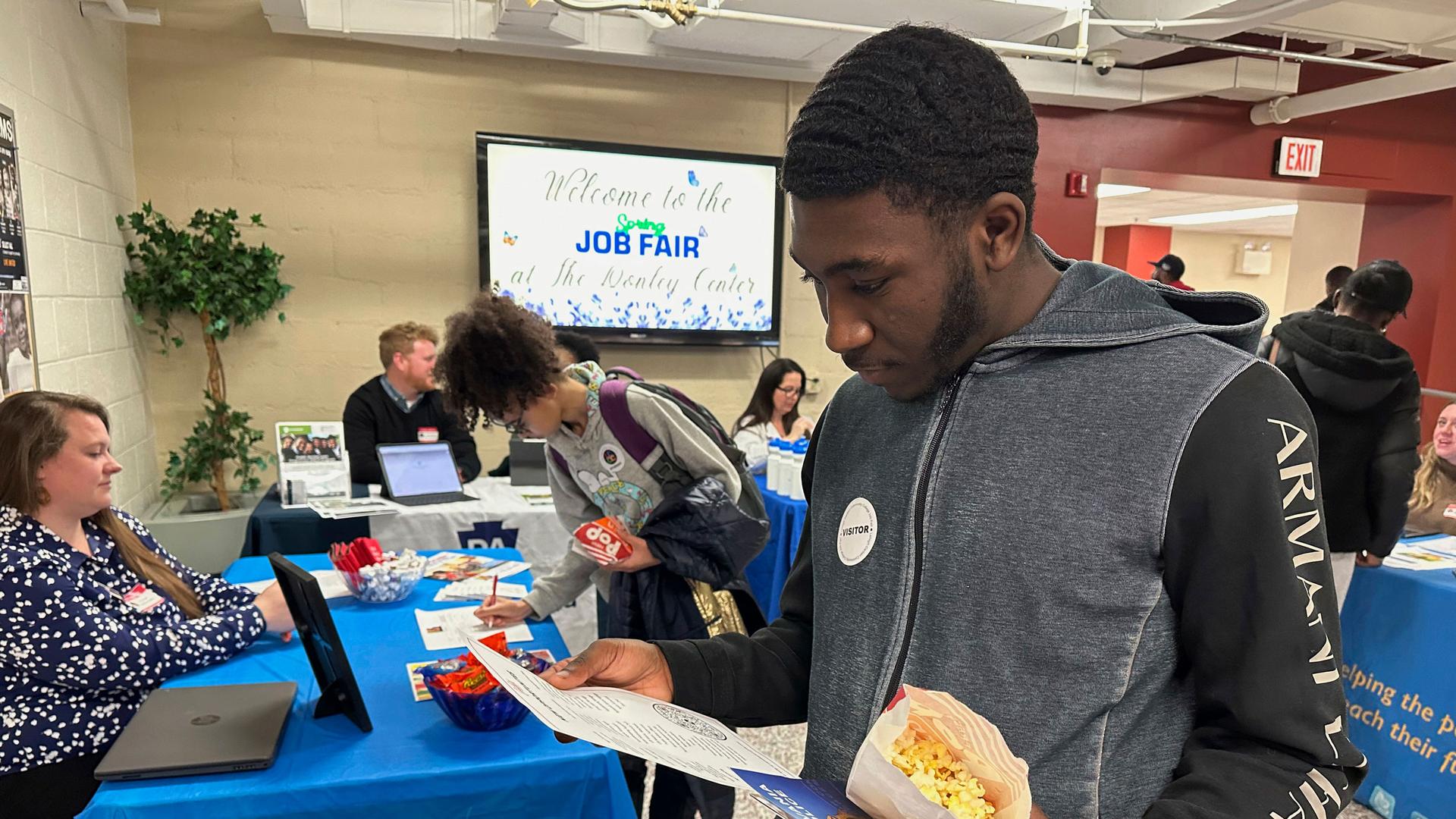 Job seeker Johannes Oveida looks over a brochure at a job fair at Lehigh Carbon Community College in Allentown, Pennsylvania, on Thursday, March 7, 2024. 