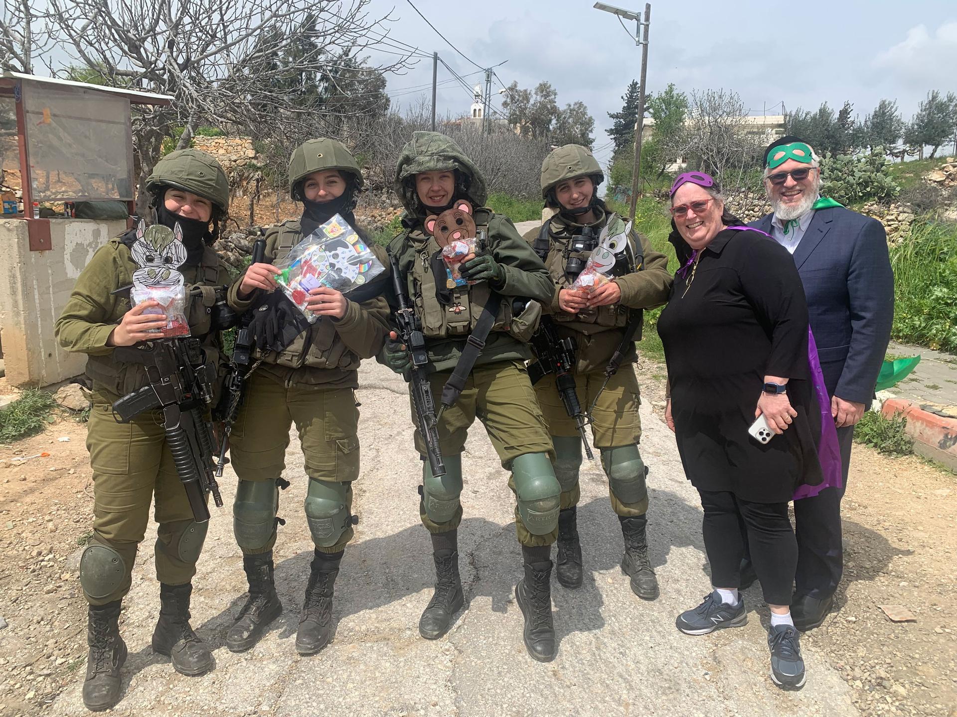 Judy and Chaim Freud, who live in the West Bank settlement of Efrat, deliver mishloach manot (Purim gift packages) to Israeli soldiers guarding the edge of the settlement on its border with Bethlehem, a Palestinian city.