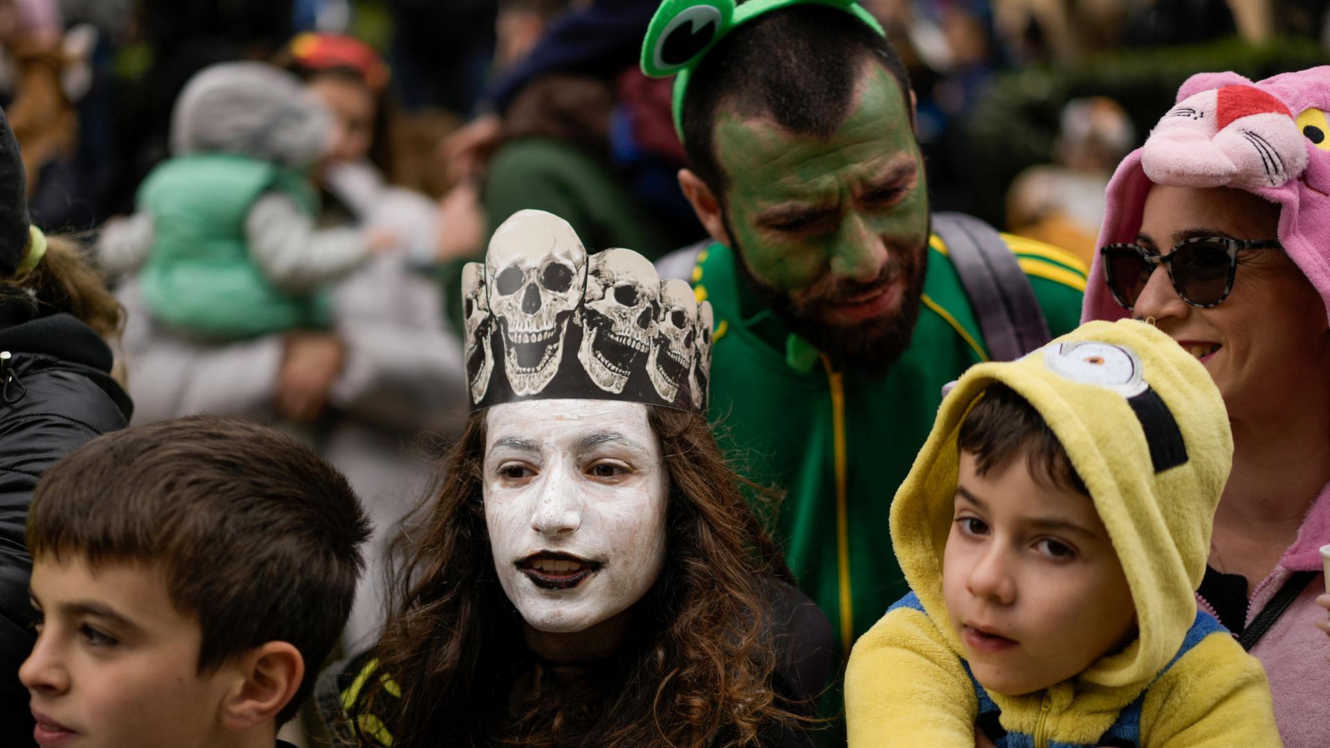 People watch the Purim parade in Jerusalem, Monday, March 25, 2024. For the first time after 42 years and amid the Israel-Hamas war, Jerusalem holds a Purim parade on Monday. 