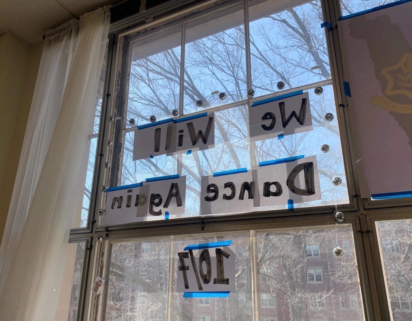pieces of paper taped to the window with the words 