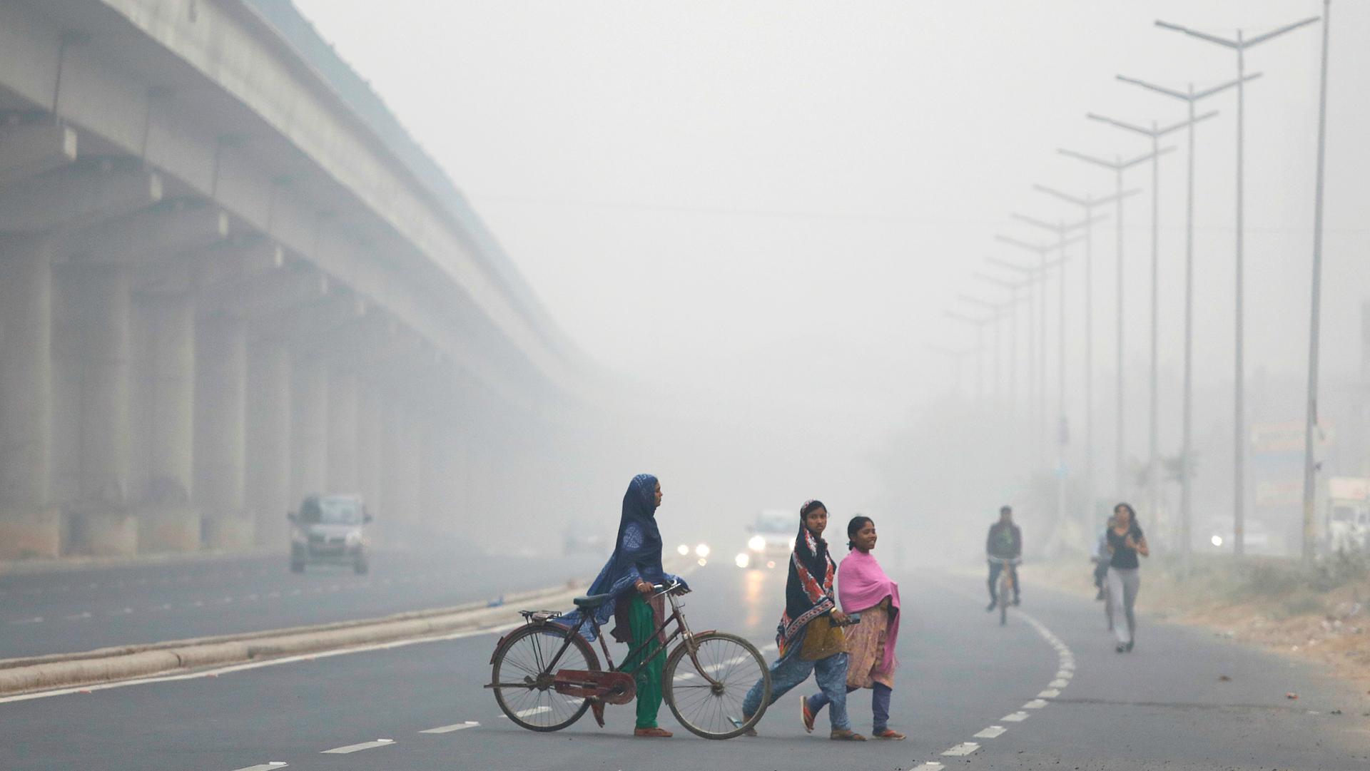 People cross the road in Delhi, India, during the height of the most recent air pollution crisis, Nov. 7, 2017.
