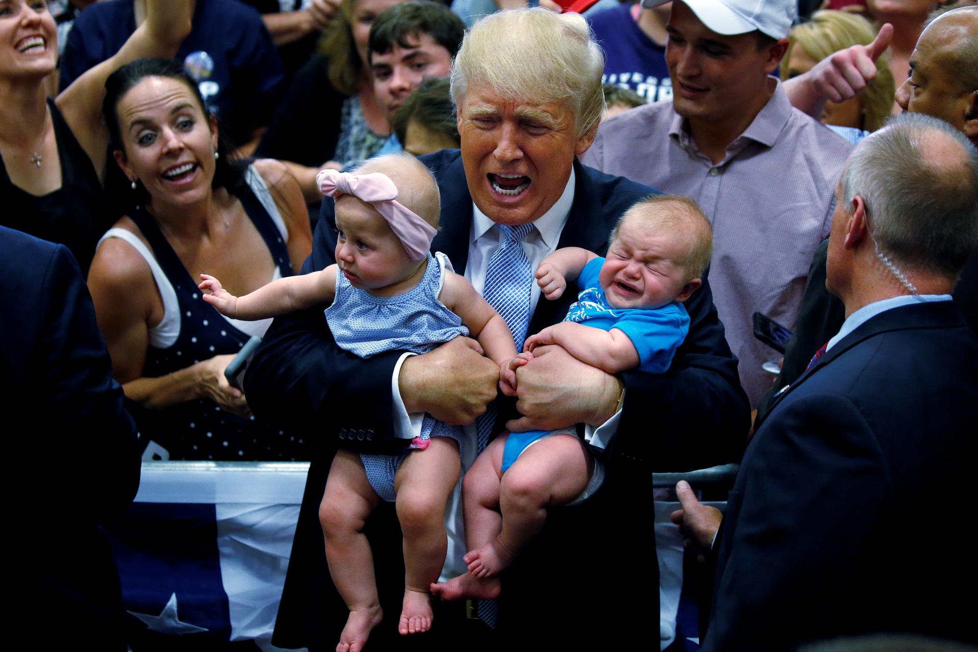 Republican presidential nominee Donald Trump holds babies at a campaign rally in Colorado Springs, Colorado, U.S., July 29, 2016. REUTERS/Carlo Allegri