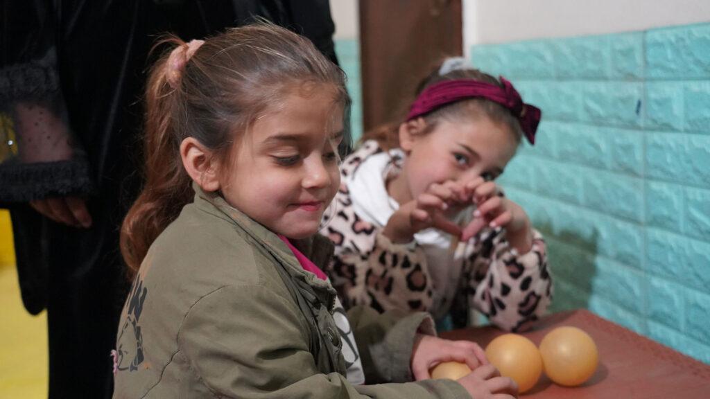 Istabraq 8, Mardia, 6, sit together at a community center in Raqqa, Syria.